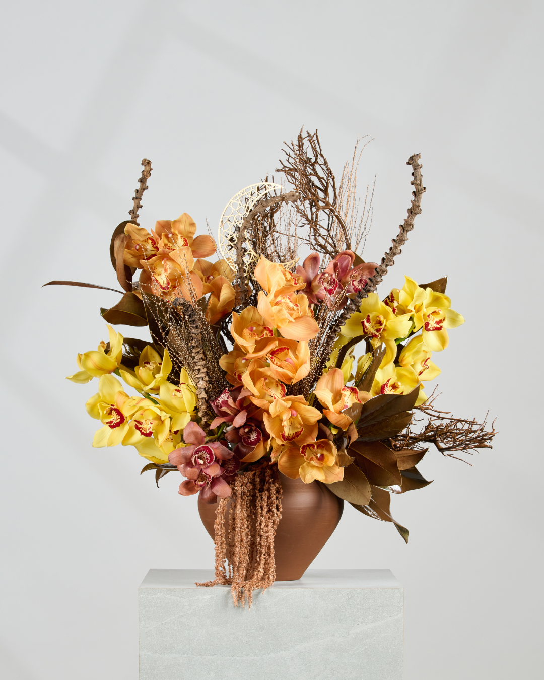 Sundown orange yellow brown Cymbidium side angle gold crescent dinner table centerpiece UAE