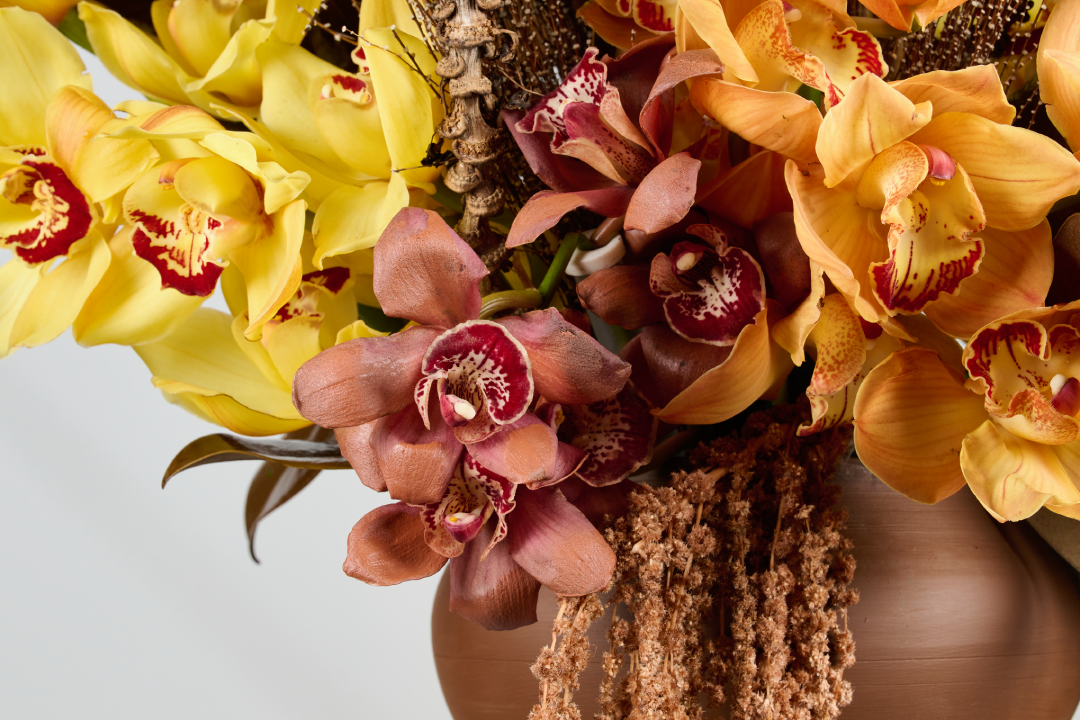 Sundown Cymbidium orchids magnolia leaves detail sunset tones Ramadan floral installation